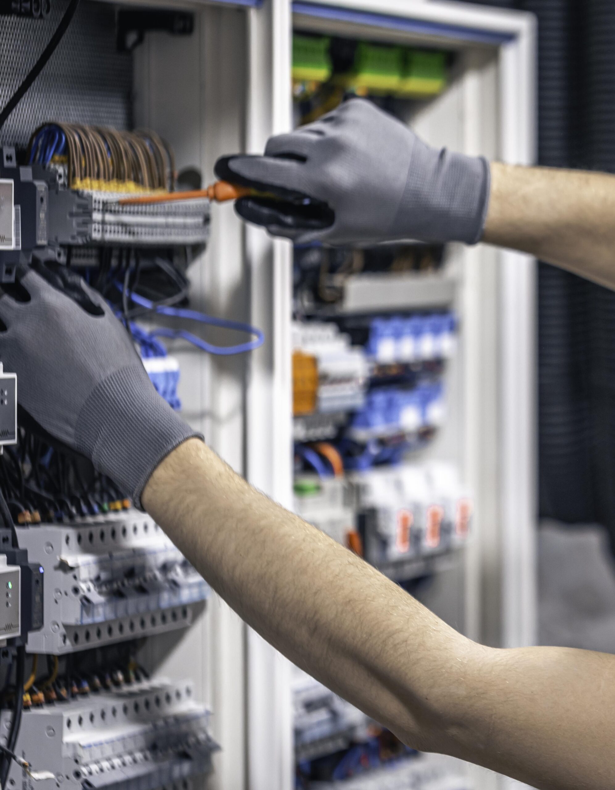male-electrician-working-switchboard-with-fuses